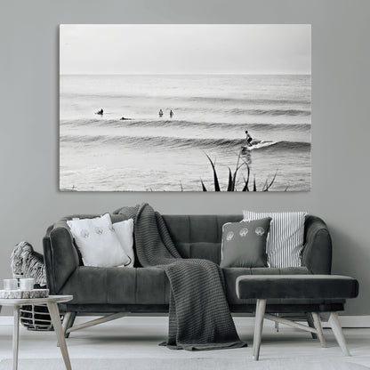 Monochrome canvas of surfers on calm ocean waves, ideal for minimalist coastal or beach-inspired interior decor.