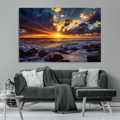 An explosive sunset over the ocean with dramatic clouds and rays of sunlight reflecting off the water, creating a vibrant and captivating view.