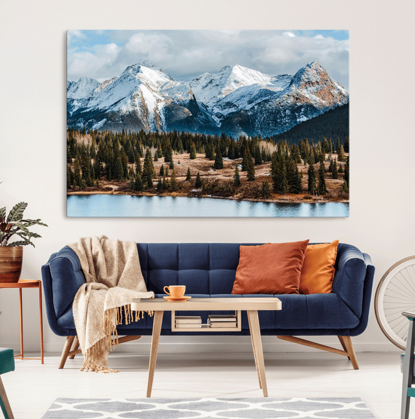 Framed canvas of snowy mountain peaks with pine forest and alpine lake, perfect for winter cabin or wilderness-inspired home decor.