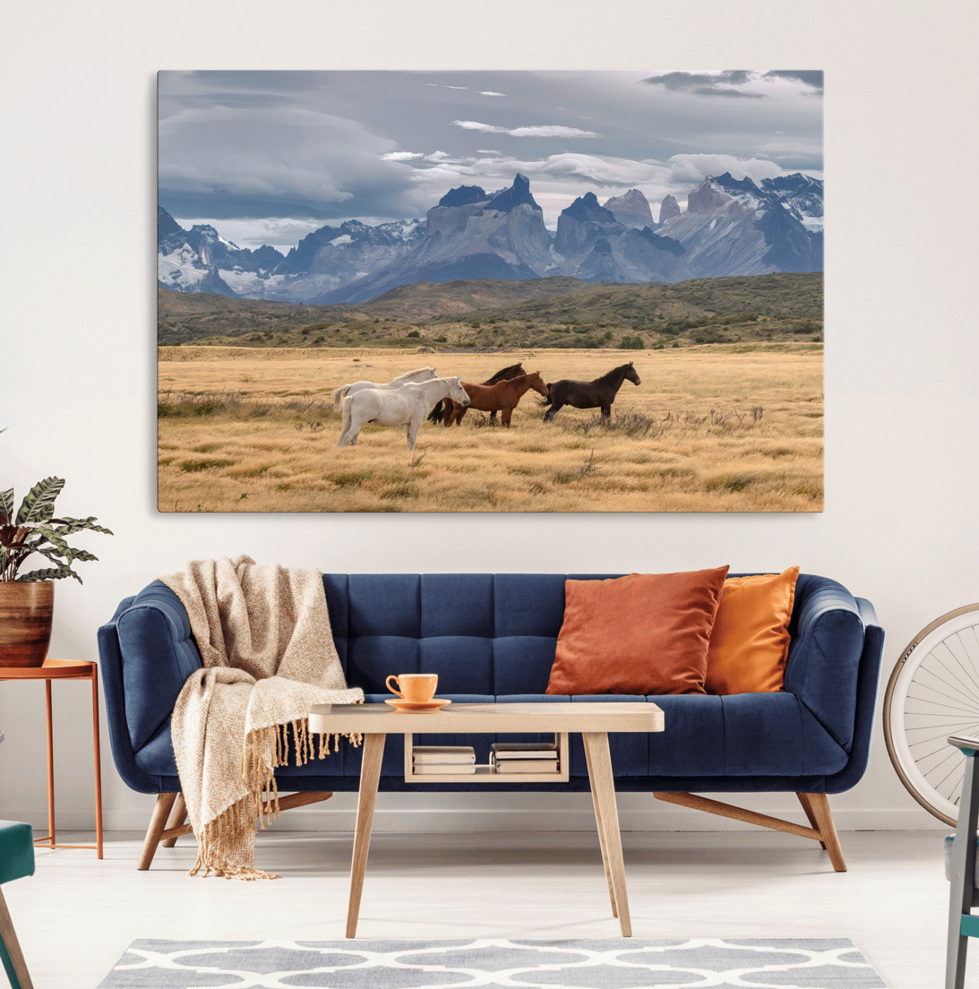 Framed canvas of wild horses grazing in golden Patagonian fields with dramatic mountain backdrop, ideal for rustic or wilderness-inspired decor.