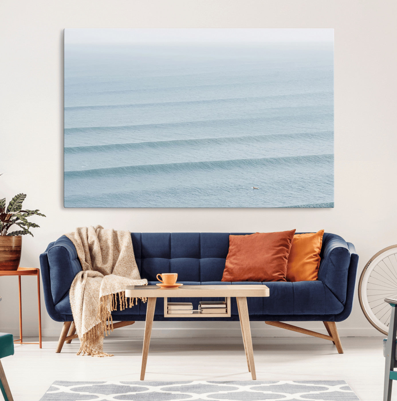 Framed canvas of repeating ocean waves with a distant solo surfer, ideal for minimalist ocean or calm coastal wall decor.