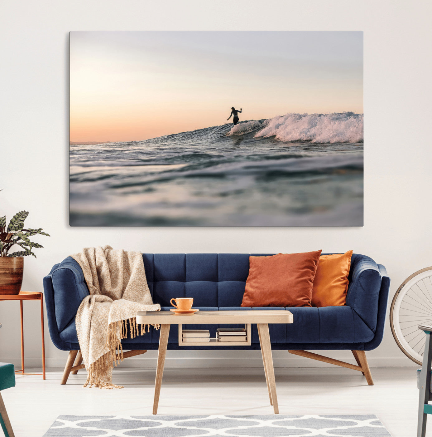 Framed canvas of a female surfer balancing on a wave at sunset, perfect for serene surf or ocean-inspired coastal decor.