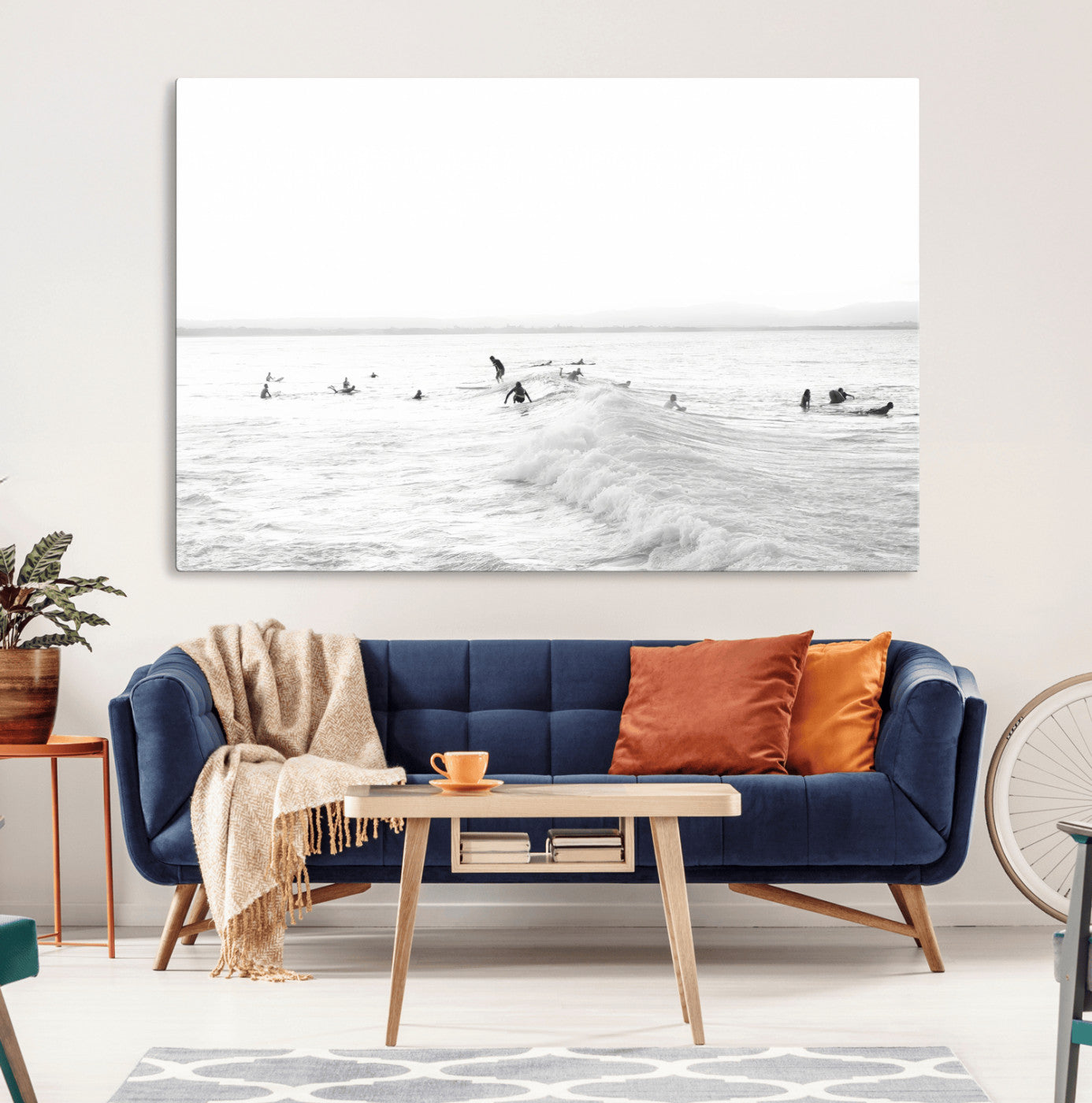 Monochrome photo of surfers riding and waiting on ocean waves, ideal for surf-themed or coastal energy wall decor.