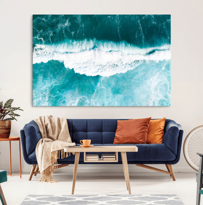 Aerial view of turquoise ocean waves crashing with white foam, perfect for tropical coastal or modern beach-style home decor.