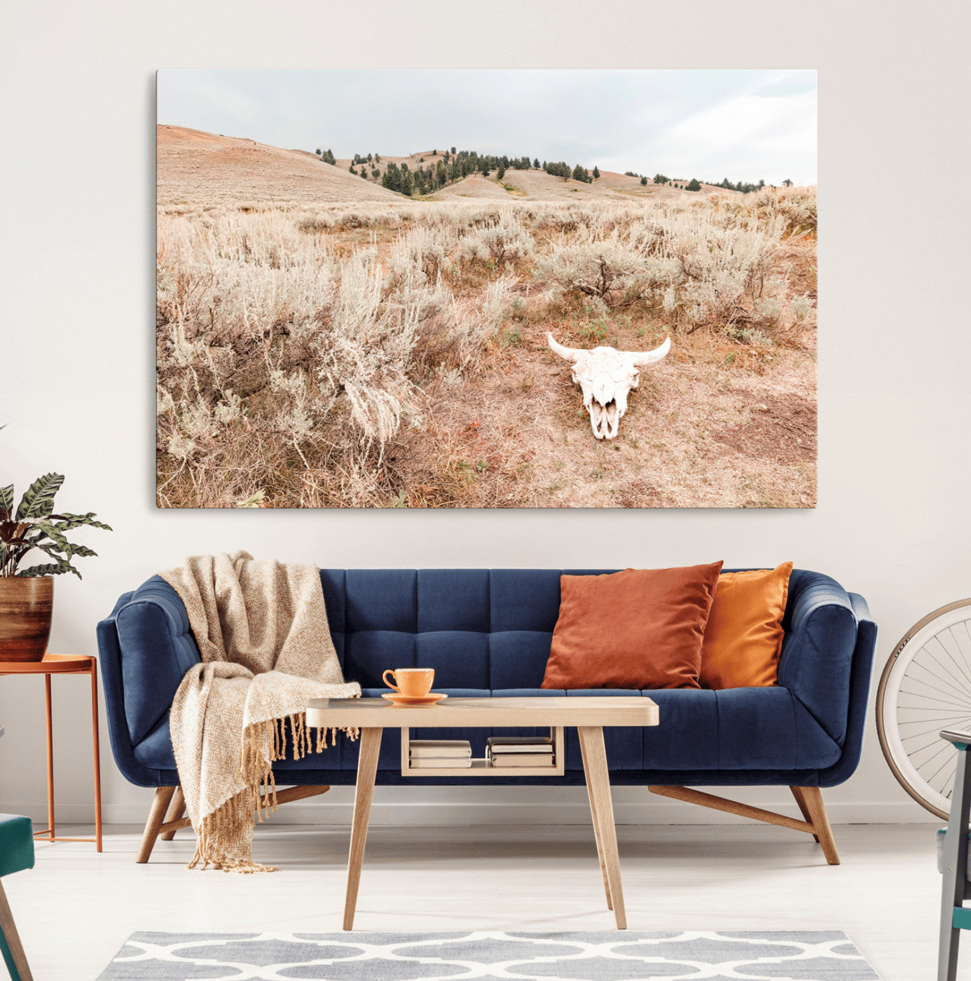 Rustic bull skull on dry sagebrush field under soft light, ideal for western minimal or desert prairie-style wall decoration.