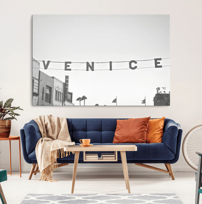 Black and white photo of Venice Beach sign and palm-lined street, perfect for urban coastal or minimalist LA-inspired wall decoration.