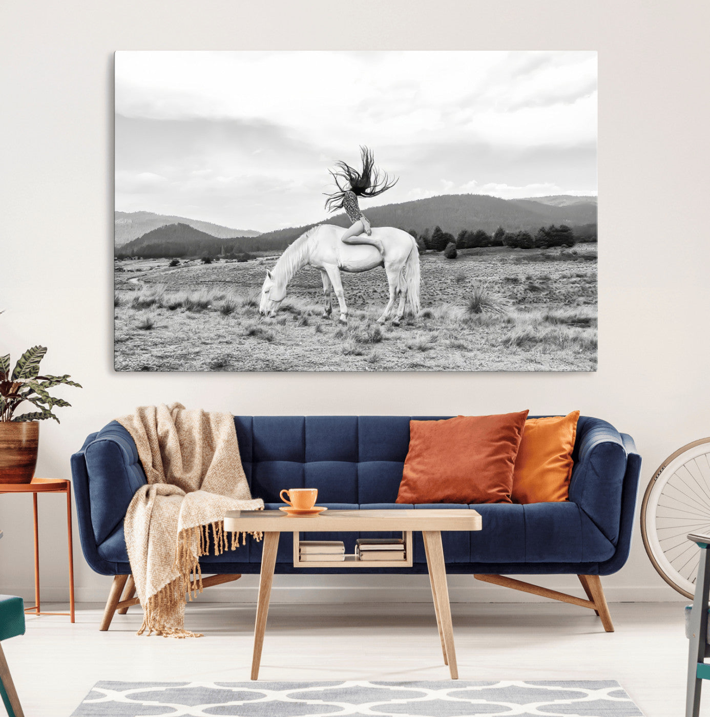 Black and white photo of a woman on a white horse in moody tones, ideal for Western Boho or modern rustic-style home decor.
