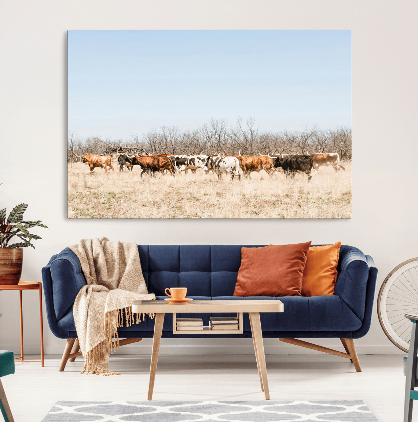 Framed wall art of Texas longhorn cattle walking through a dry, neutral-toned prairie, perfect for rustic farmhouse or western-themed home decor.