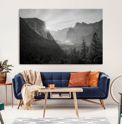 Black and white landscape of Yosemite with sun rays peeking over El Capitan, ideal for moody nature or modern rustic decor.