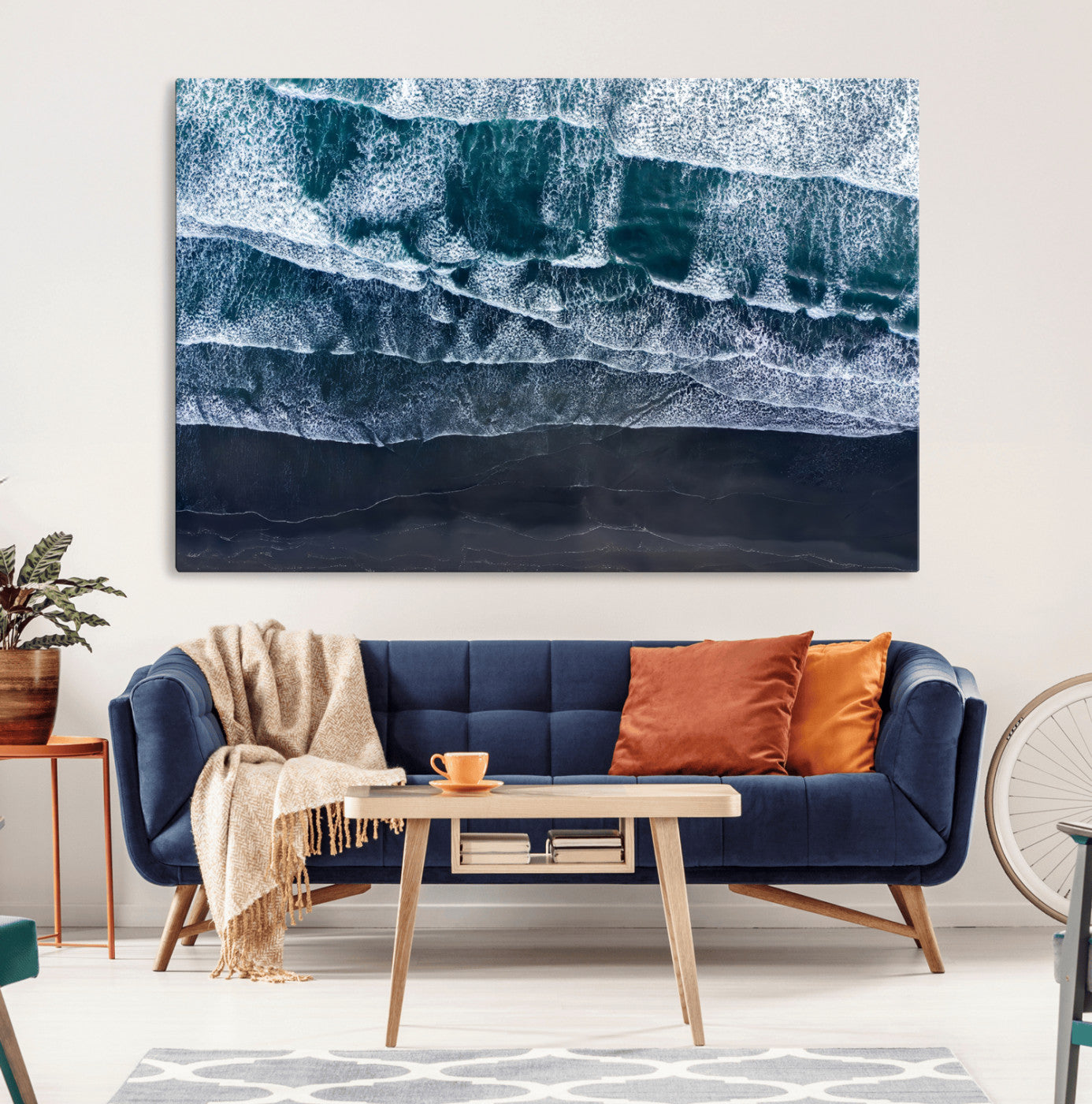 Canvas of aerial ocean waves crashing onto a black sand beach in moody tones, ideal for modern coastal or minimalist home decor.