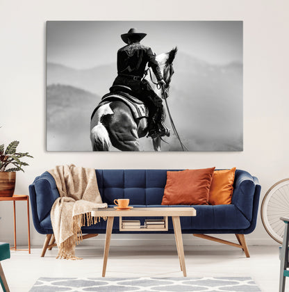 Black and white canvas of a cowboy on horseback with moody tones, perfect for rustic western or country-inspired home decor.
