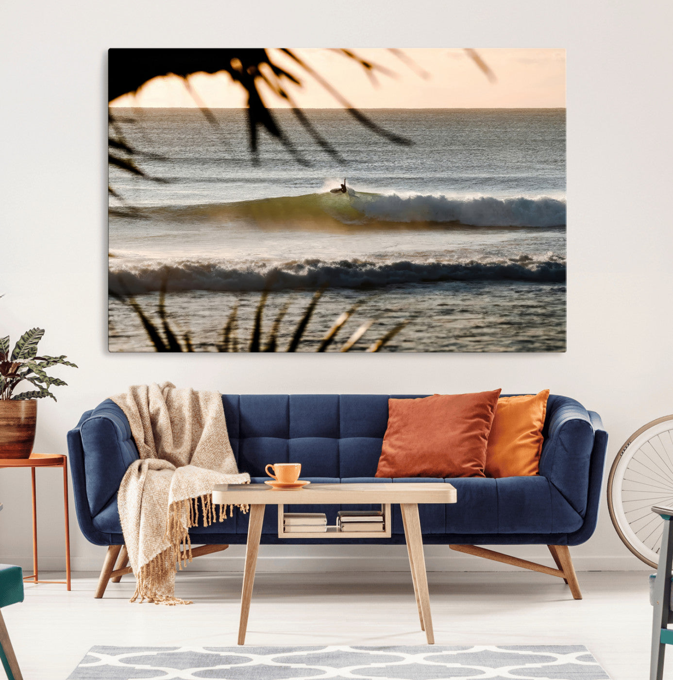 Photo of a surfer riding a golden hour wave at sunset, with tropical tones and dreamy light, perfect for tropical boho or coastal home decor.