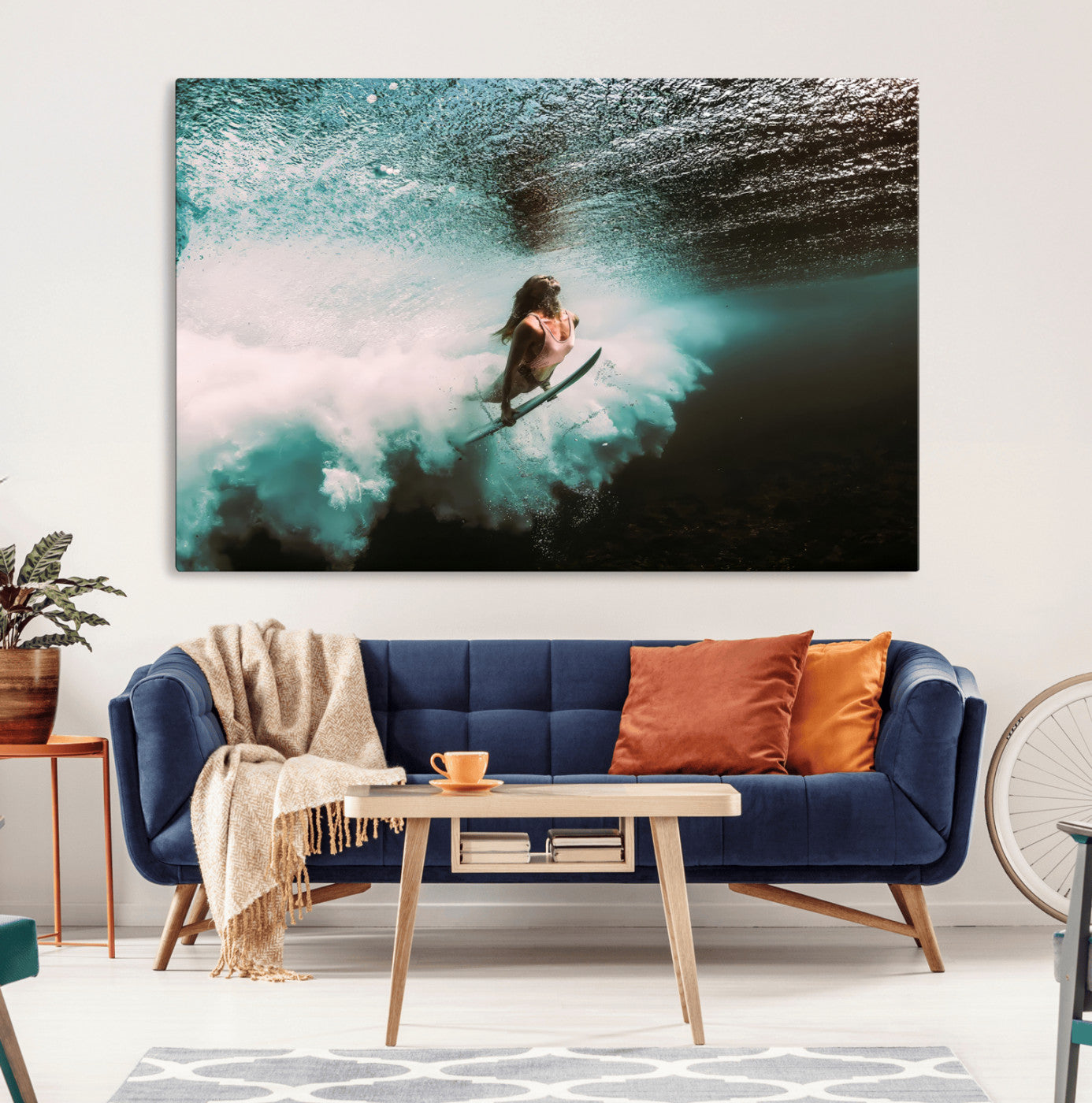 Vibrant underwater photo of a female surfer diving through turquoise waves, perfect for coastal boho or surf-inspired home decor.