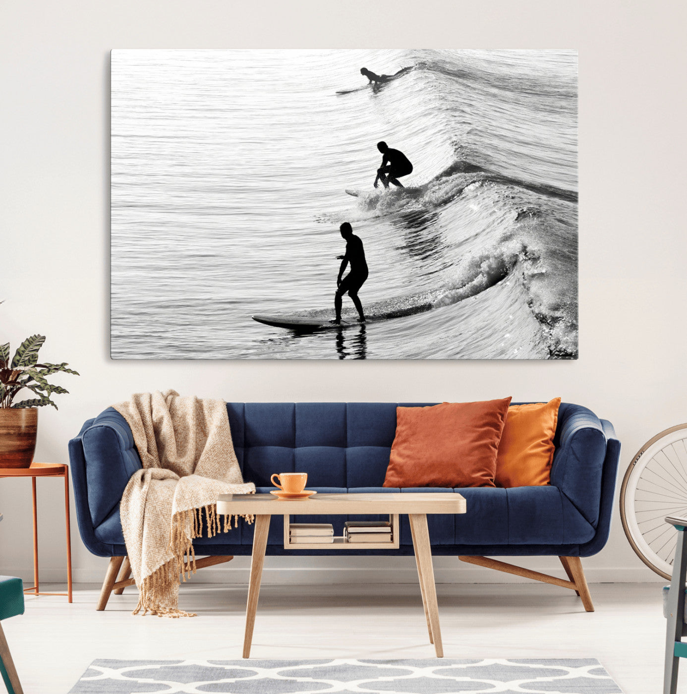 Black and white photo of surfers riding waves in a moody, high-contrast scene, ideal for modern coastal or surf-inspired home decor.