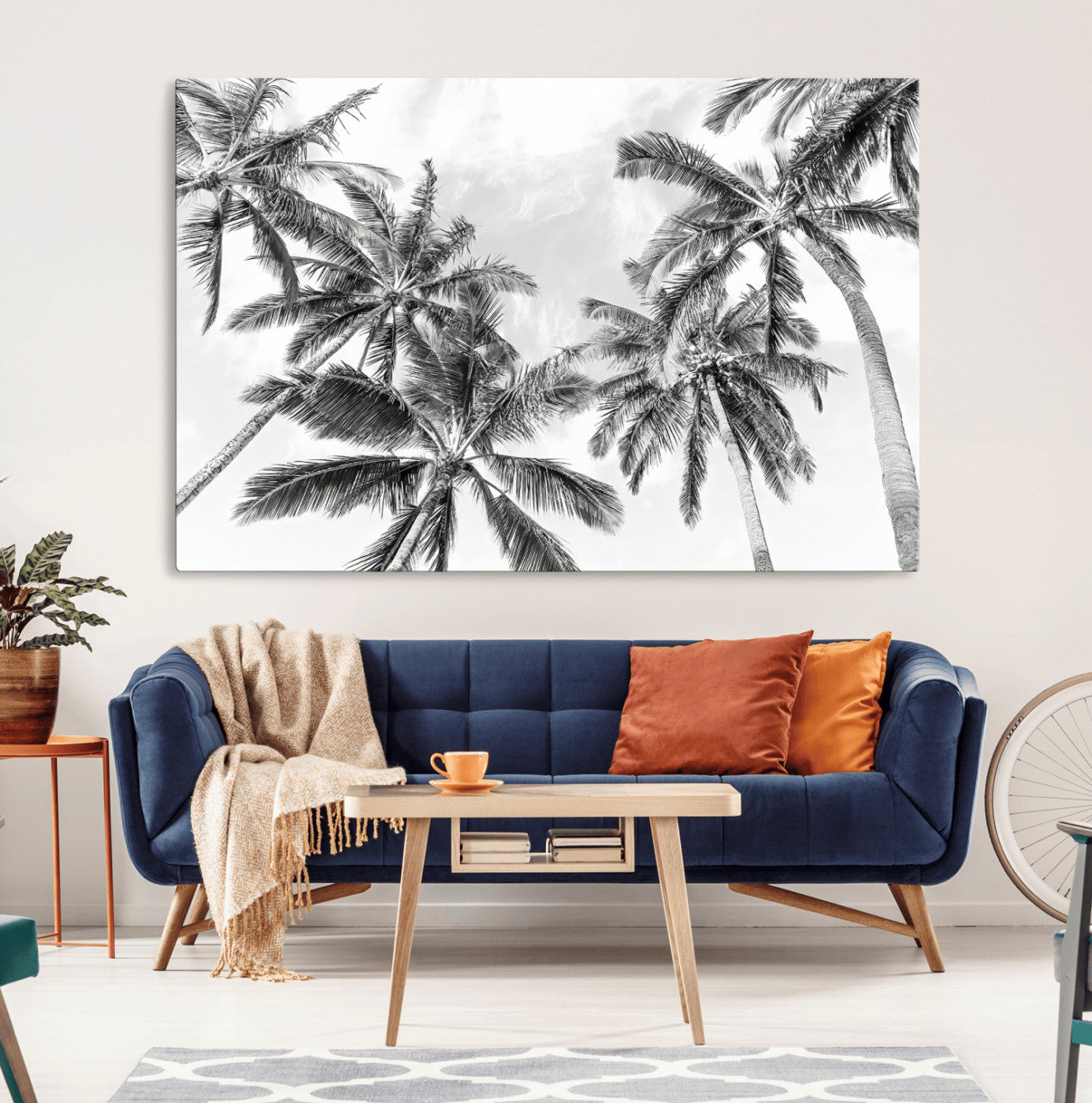 Black and white tropical palm trees viewed from below, swaying gently against a bright sky, creating a serene and elegant coastal atmosphere.