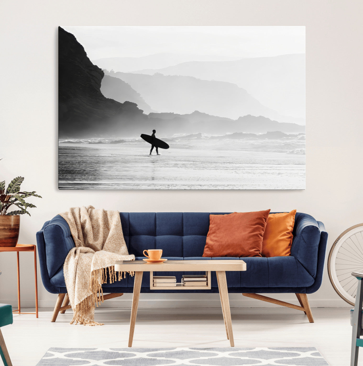 A lone surfer walking along a misty beach with cliffs in the background, carrying their board, capturing a serene and minimal ocean moment.