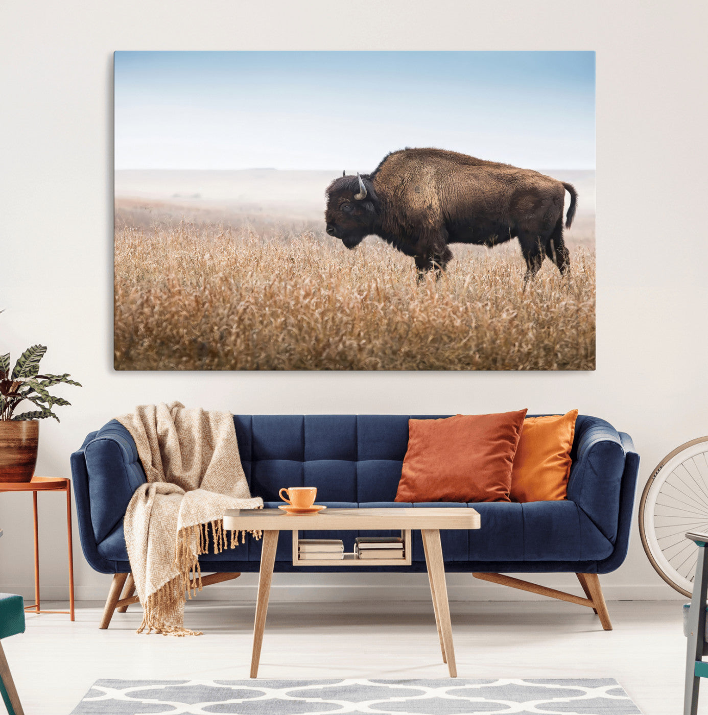 A majestic bison standing in an open prairie field, its strong form blending into the golden grass under a vast blue sky, evoking the wild spirit of the American plains.