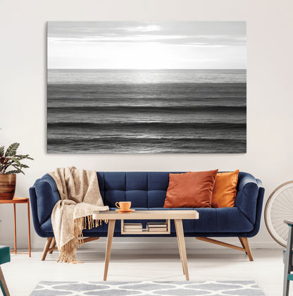 Minimalist black and white ocean view with layered waves reflecting sunlight, evoking a sense of calm and coastal serenity.