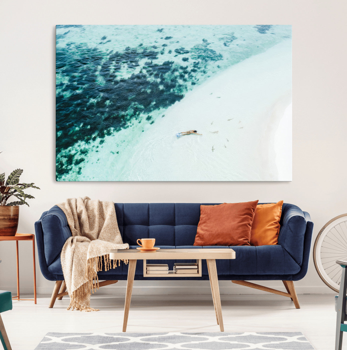 Canvas featuring an aerial view of a swimmer in shallow turquoise waters with coral patterns, ideal for tropical coastal home decor.