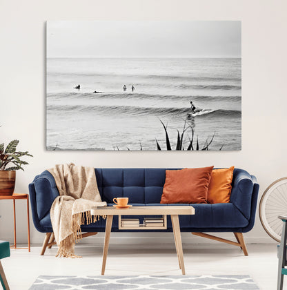 Monochrome canvas of surfers on calm ocean waves, ideal for minimalist coastal or beach-inspired interior decor.
