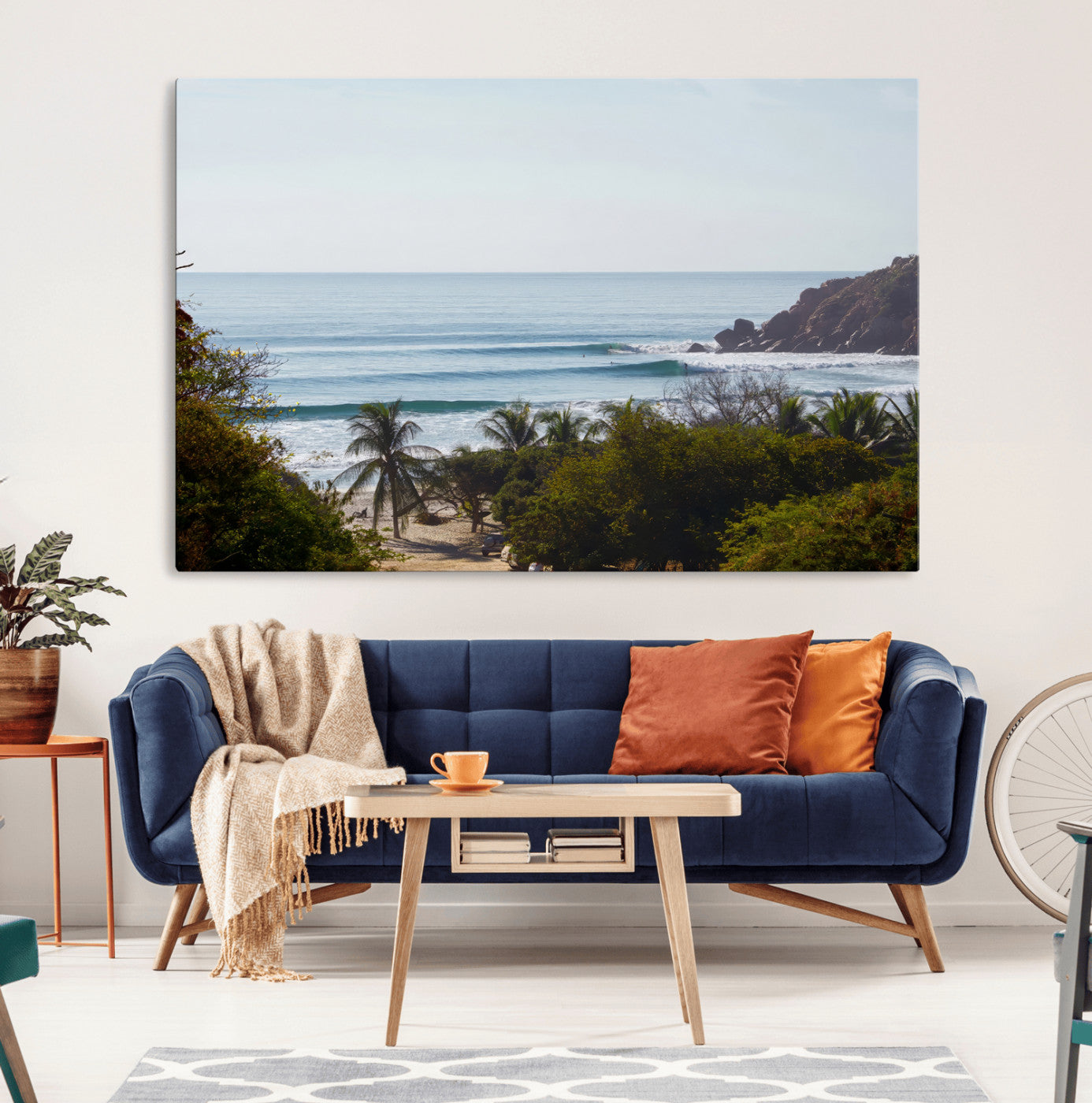 View of calm ocean waves with palm trees and a tropical coastline, ideal for coastal boho or beach-themed wall decor.