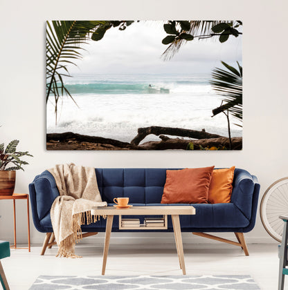 Tropical beach view with palm trees and surfer riding a wave, perfect for boho or coastal-inspired interior wall decor.