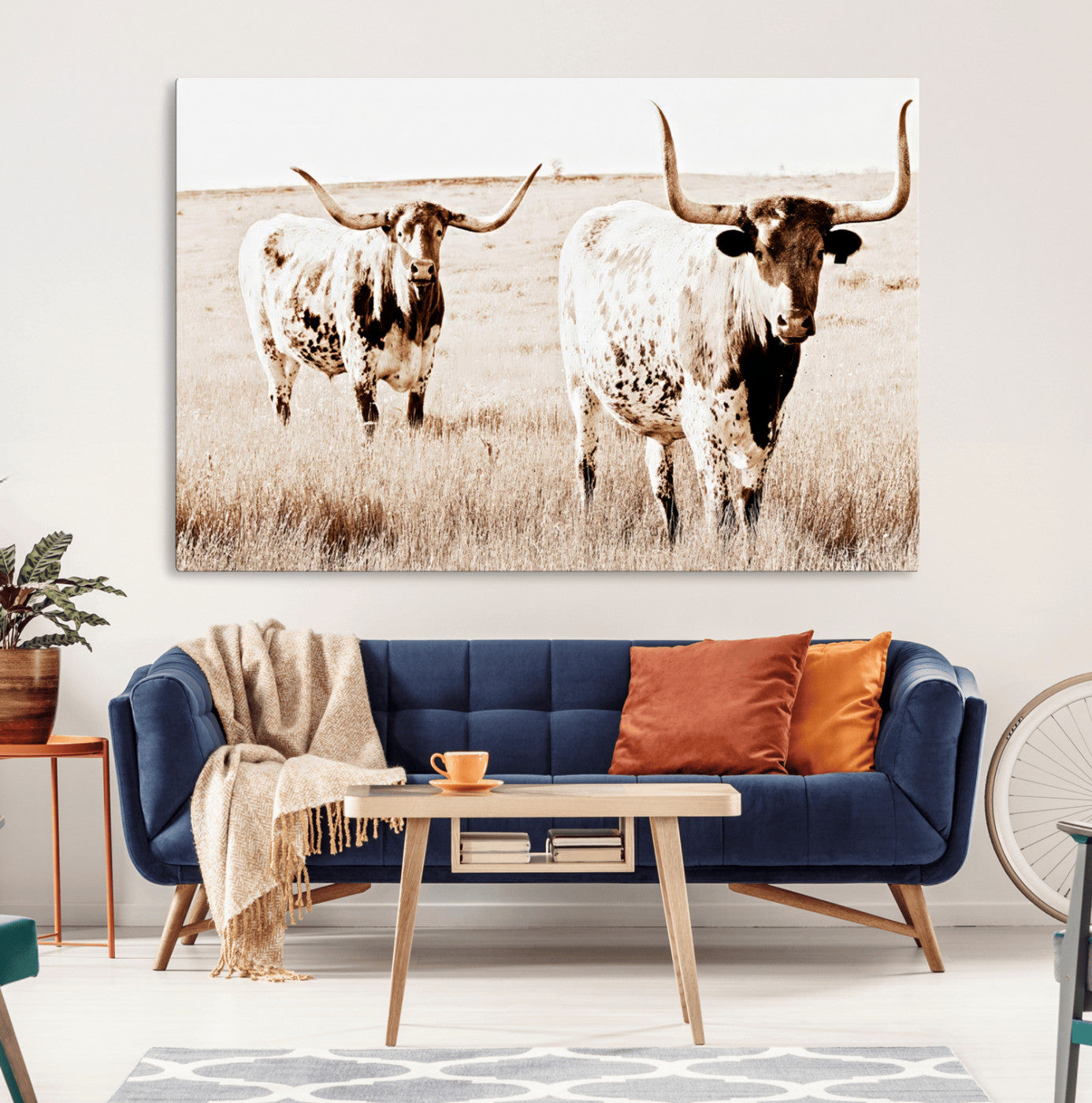 Two Texas longhorn cows standing in a sepia-toned pasture, evoking rustic charm perfect for farmhouse or western country interiors. (