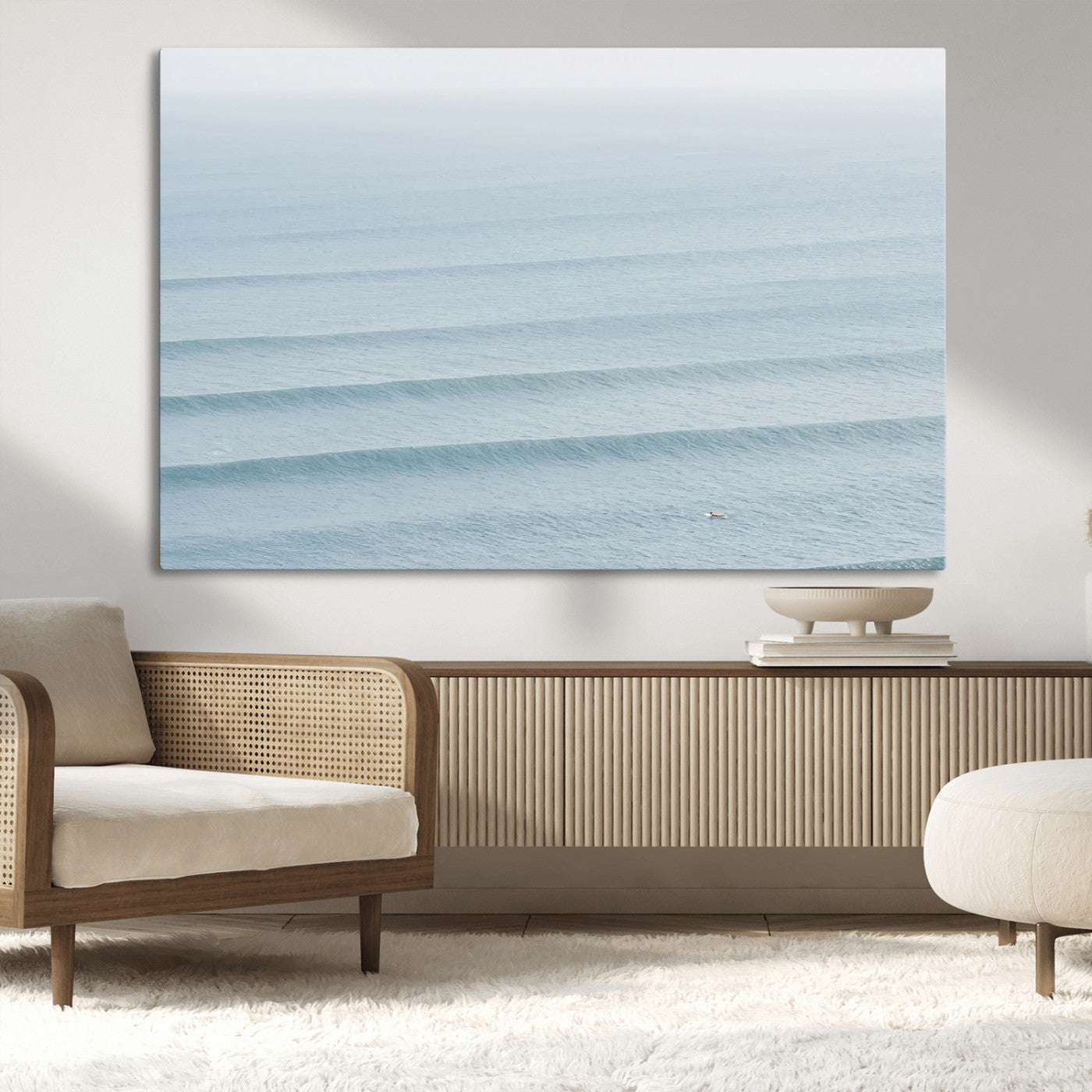 Framed canvas of repeating ocean waves with a distant solo surfer, ideal for minimalist ocean or calm coastal wall decor.