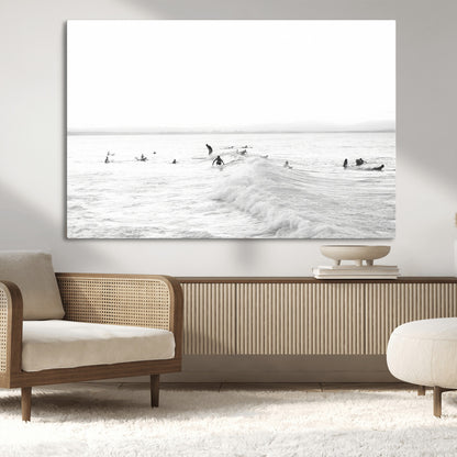 Monochrome photo of surfers riding and waiting on ocean waves, ideal for surf-themed or coastal energy wall decor.