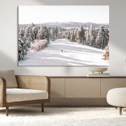 Bright ski trail lined with snow-covered pines and a skier in orange, perfect for alpine adventure or winter sports-inspired decor.