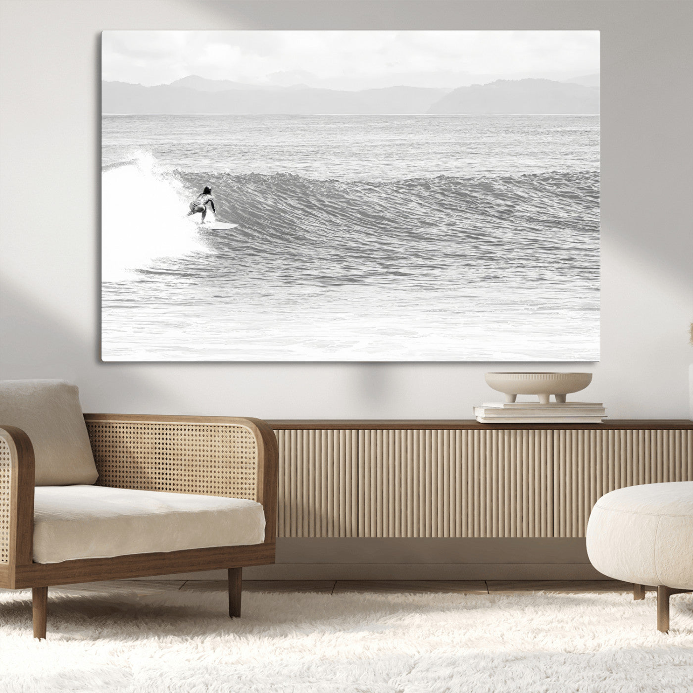 Monochrome photo of a surfer riding a wave with distant mountains, ideal for coastal motion or black and white surf-themed wall decor.