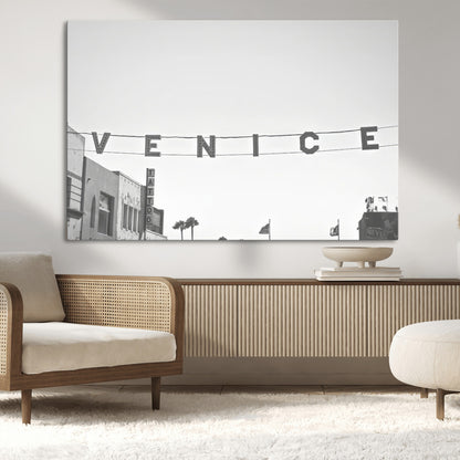 Black and white photo of Venice Beach sign and palm-lined street, perfect for urban coastal or minimalist LA-inspired wall decoration.