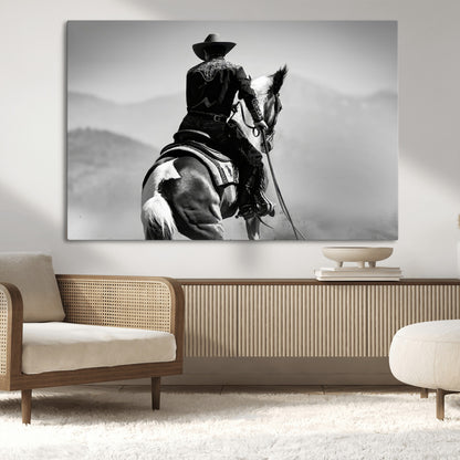 Black and white canvas of a cowboy on horseback with moody tones, perfect for rustic western or country-inspired home decor.