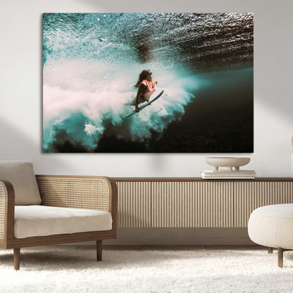 Vibrant underwater photo of a female surfer diving through turquoise waves, perfect for coastal boho or surf-inspired home decor.