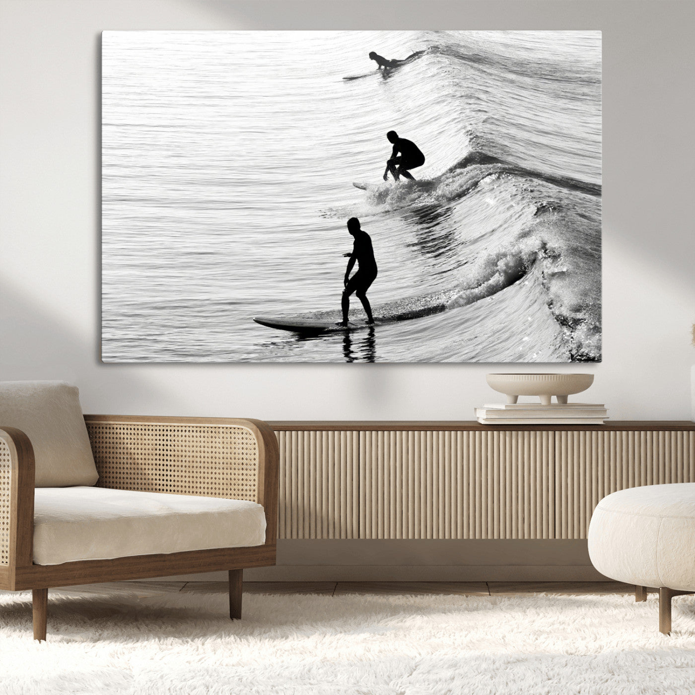 Black and white photo of surfers riding waves in a moody, high-contrast scene, ideal for modern coastal or surf-inspired home decor.