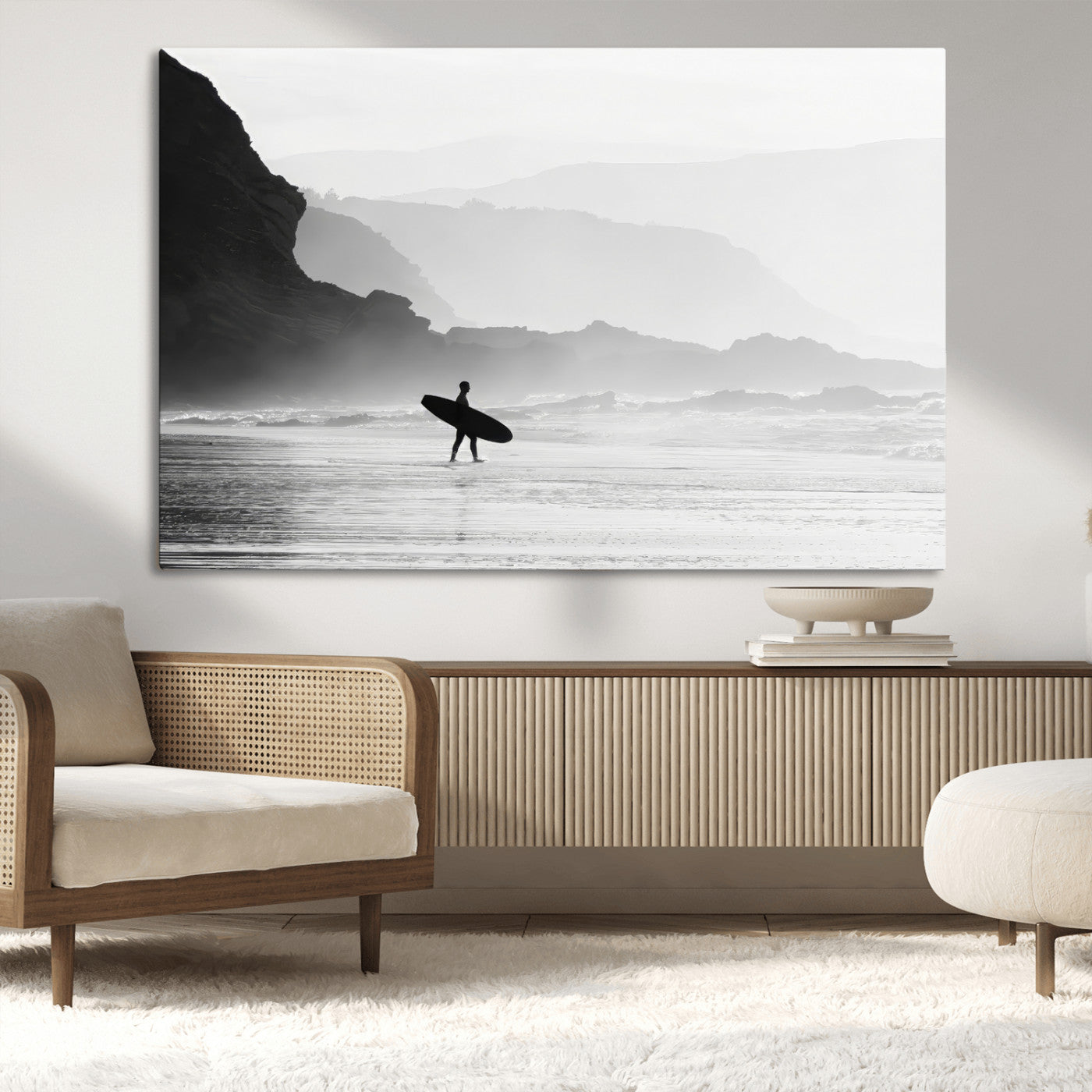 A lone surfer walking along a misty beach with cliffs in the background, carrying their board, capturing a serene and minimal ocean moment.