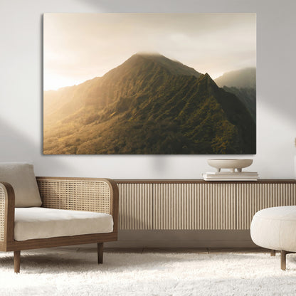 Sunlit mountain peak with mist rolling over its rugged slopes, bathed in golden light, creating a warm and tranquil nature-inspired scene.