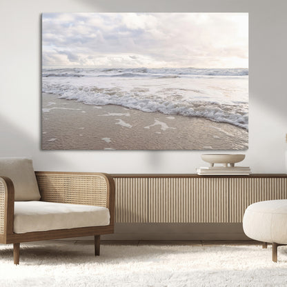 Peaceful ocean waves rolling onto the sandy shore under soft light, perfect for neutral or coastal minimalist decor themes.