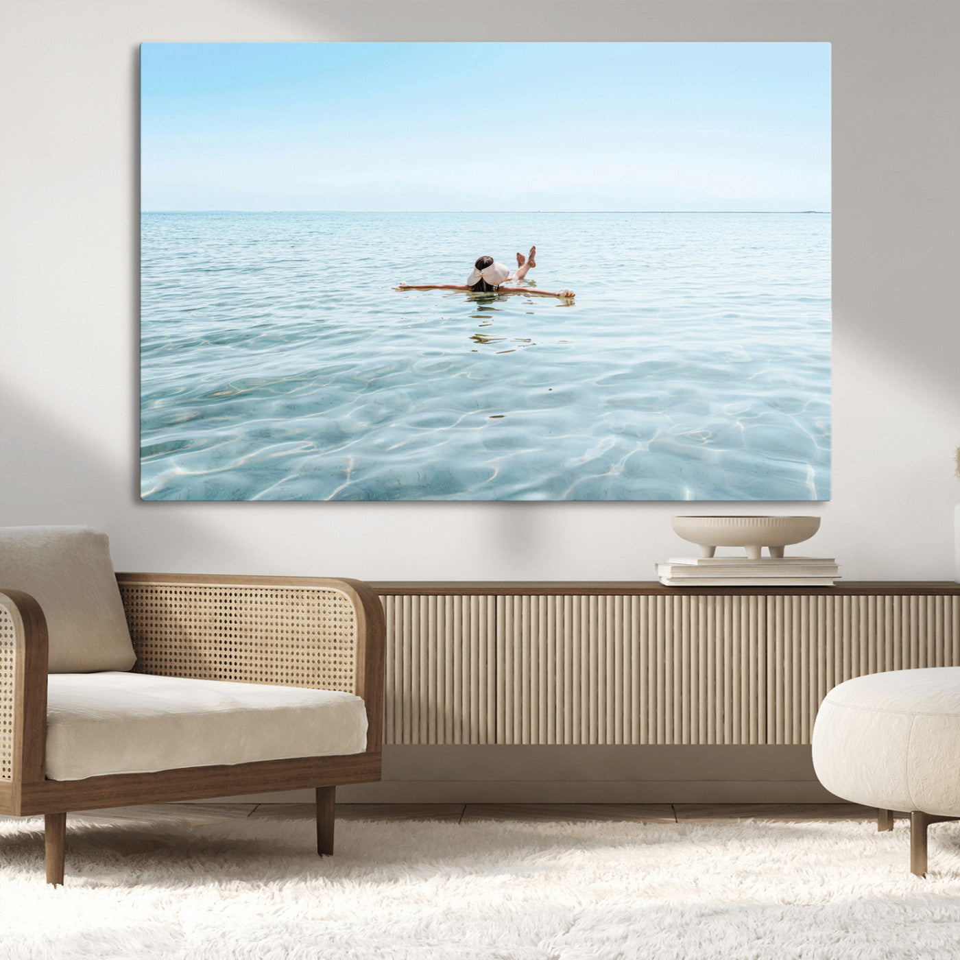 A peaceful minimalist scene of a person floating on crystal-clear water, surrounded by a vast open horizon, capturing relaxation and serenity in a tranquil aquatic setting.