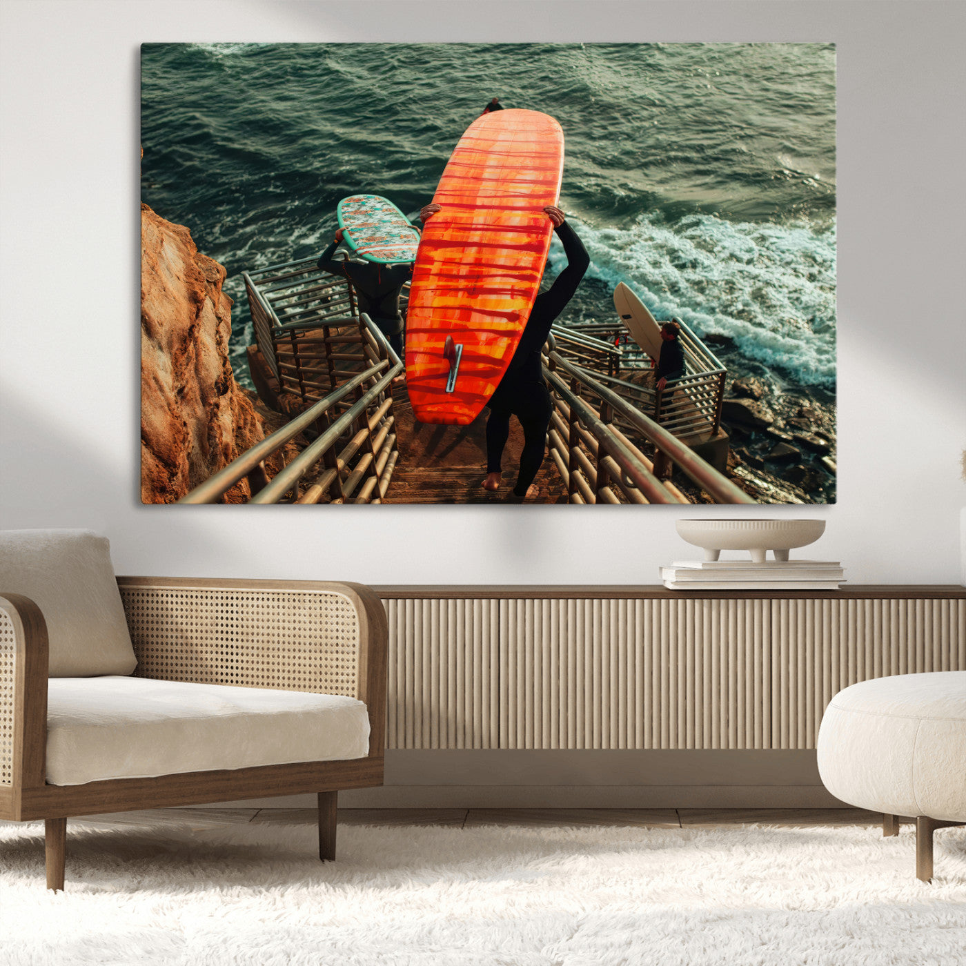 A surfer carrying a bold orange surfboard down a rugged staircase toward the ocean, bathed in golden hour light, capturing the energy of coastal adventure.