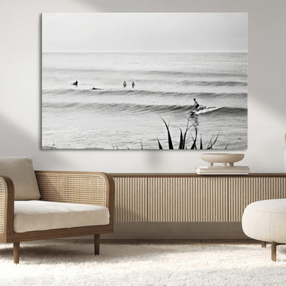 Monochrome canvas of surfers on calm ocean waves, ideal for minimalist coastal or beach-inspired interior decor.