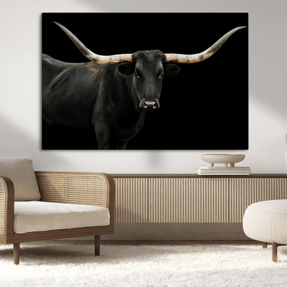 Close-up of a black Texas longhorn with large curved horns on black background, ideal for rustic farmhouse or modern western interiors.