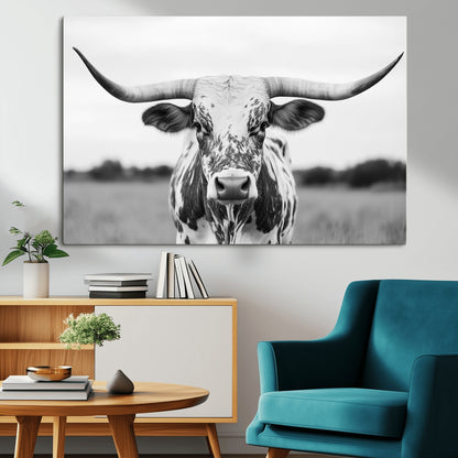Capture the strength and elegance of nature with this striking black and white portrait of a longhorn cow. Its powerful presence makes a bold statement in any room.