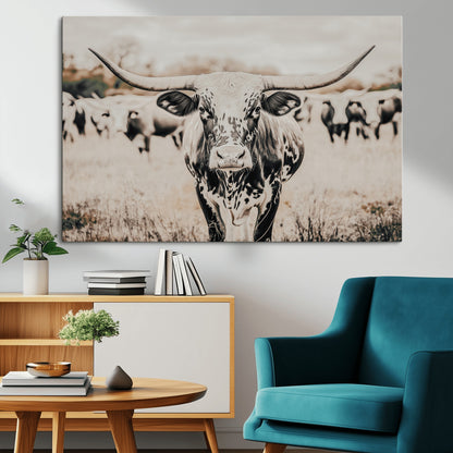 Canvas of a speckled Texas longhorn standing boldly in a field with a herd behind, perfect for rustic western or farmhouse wall decor.