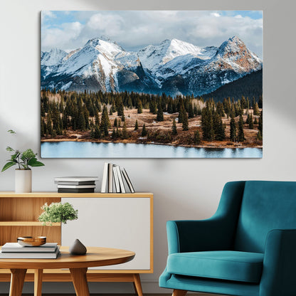Framed canvas of snowy mountain peaks with pine forest and alpine lake, perfect for winter cabin or wilderness-inspired home decor.