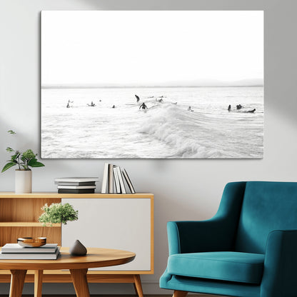 Monochrome photo of surfers riding and waiting on ocean waves, ideal for surf-themed or coastal energy wall decor.