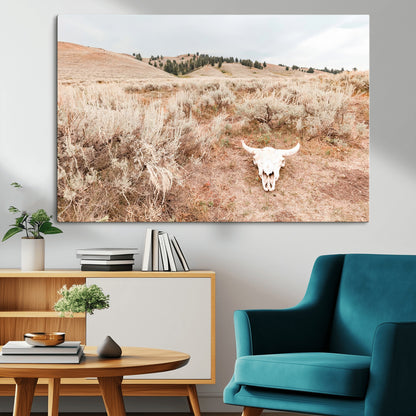 Rustic bull skull on dry sagebrush field under soft light, ideal for western minimal or desert prairie-style wall decoration.
