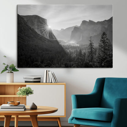 Black and white landscape of Yosemite with sun rays peeking over El Capitan, ideal for moody nature or modern rustic decor.