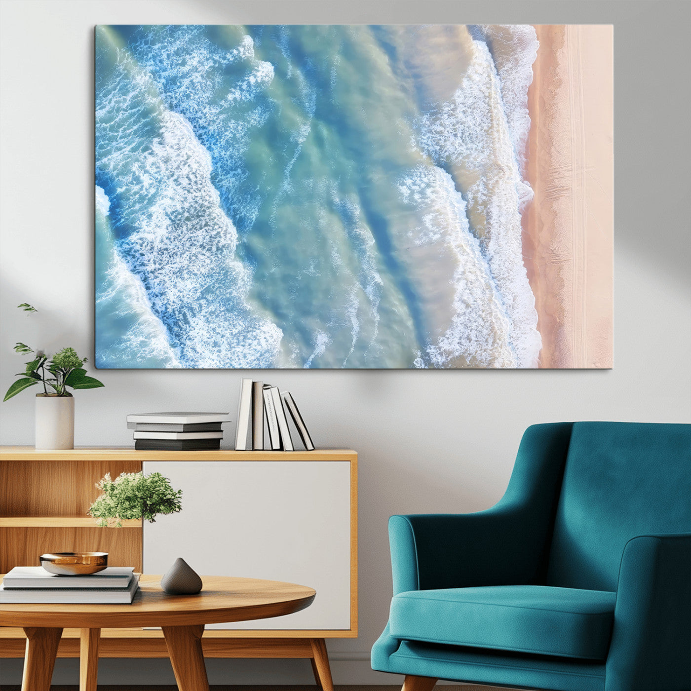 Aerial photo of soft blue waves meeting sandy shore, perfect for modern coastal or beach-themed decor with a light and tranquil aesthetic.