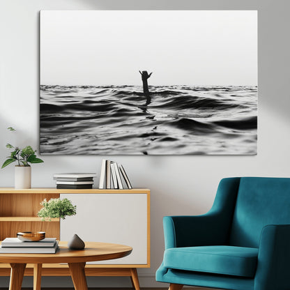 Black and white ocean with a hand making a surfer sign among dark waves, creating a dramatic and minimalist seascape with bold contrast.